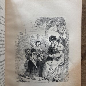 May include: An antique black and white illustration from a book depicts a robed figure with a staff, seated under a tree, surrounded by children. The text at the bottom reads "THE DUCAT AND THE FARTHING."