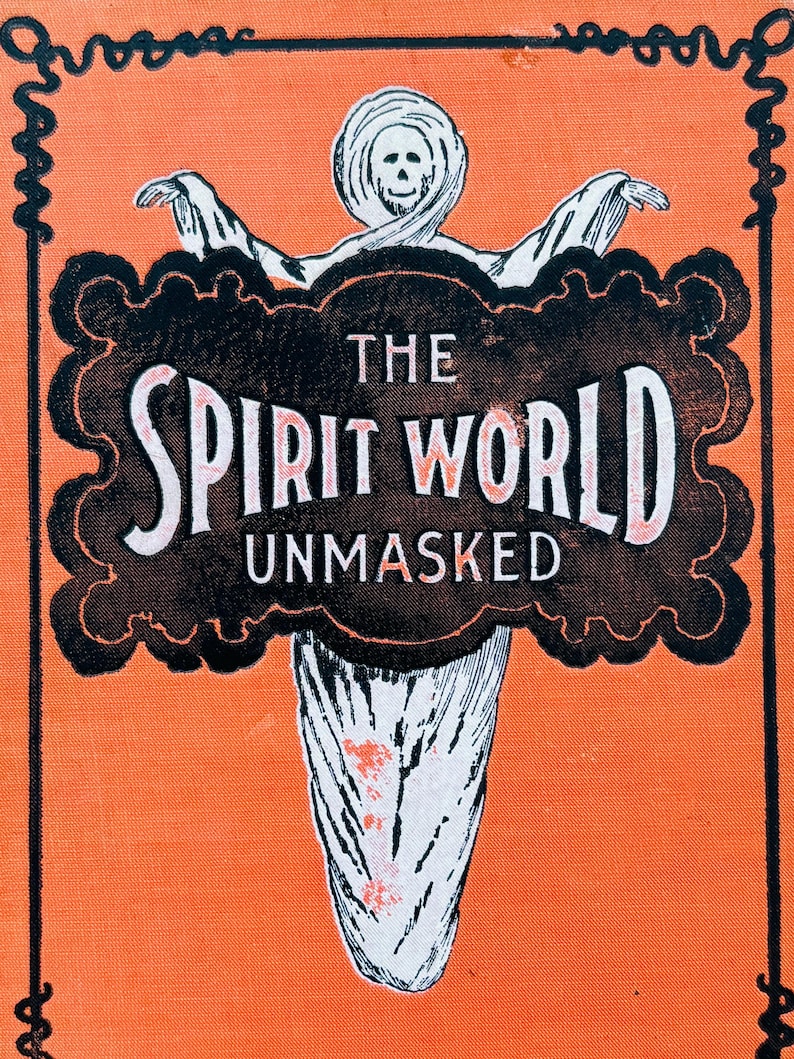 May include: An orange background with a black and white illustration of a ghost-like figure. The text "THE SPIRIT WORLD UNMASKED" is displayed in a black cloud-shaped frame. The image has a vintage, Halloween theme.