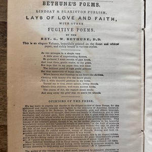 May include: An open book with the title "Bethune's Poems" by Lindsay & Blakiston. The pages display printed text, including the author's name, poem titles, and opinions from the press. The book is aged with a vintage aesthetic.