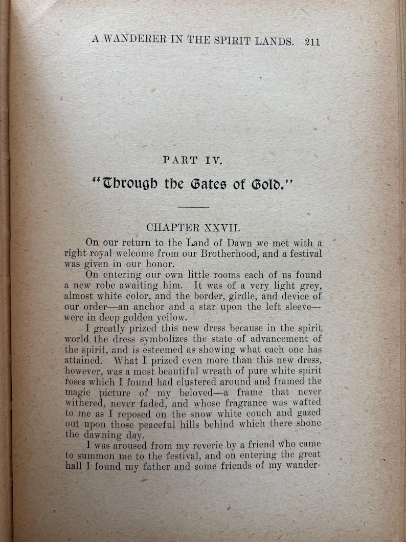 May include: Open book page with text from "A Wanderer in the Spirit Lands." The text includes the title "Through the Gates of Gold" and Chapter XXVII. The paper has a beige tone with black text.