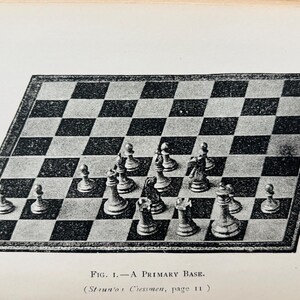 May include: An illustration of a chessboard with chess pieces in a starting position. The board is black and white checkered, with a dark border. The chess pieces are detailed and arranged for the start of a game. Text at the bottom reads "FIG. 1. - A PRIMARY BASE."