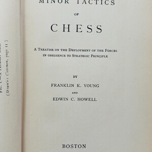 May include: Open book page with the title "The Minor Tactics of Chess" in large, bold letters. Below, the text reads "A Treatise on the Deployment of the Forces in Obedience to Strategic Principle." The book was published in Boston in 1927.