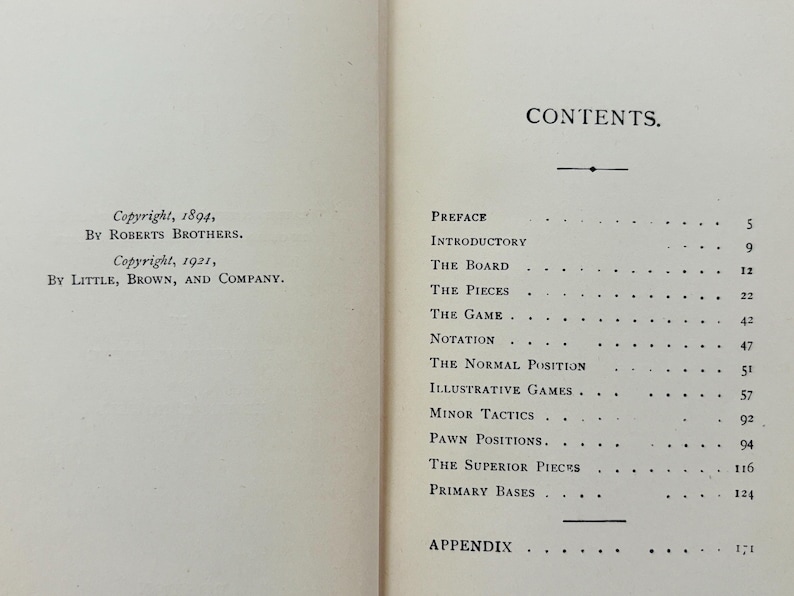 May include: Open book pages with text. The left page shows copyright information from 1894 and 1921. The right page displays a table of contents with titles like "The Board" and "The Pieces".