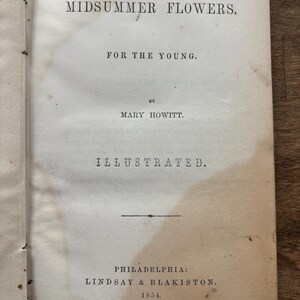 May include: Open book page with the title "MIDSUMMER FLOWERS" and the subtitle "FOR THE YOUNG." The author's name is Mary Howitt. The book is illustrated and published in Philadelphia by Lindsay & Blakiston in 1854.