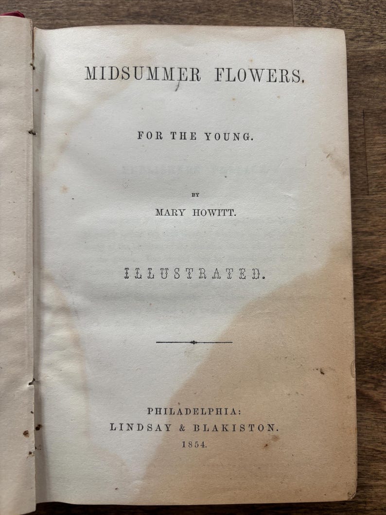 May include: Open book page with the title "MIDSUMMER FLOWERS" and the subtitle "FOR THE YOUNG." The author's name is Mary Howitt. The book is illustrated and published in Philadelphia by Lindsay & Blakiston in 1854.