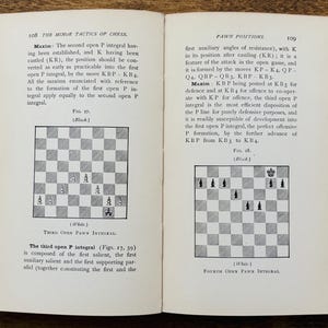 May include: Open book with text and chess diagrams. The left page features a diagram labeled "Third Open Pawn Integral." The right page shows a diagram labeled "Fourth Open Pawn Integral." The book is open on a wooden surface.
