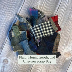 May include: A bag of fabric scraps in various plaid, houndstooth, and chevron patterns. The scraps are in shades of blue, green, red, and white.