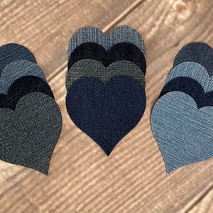 May include: A set of 15 denim heart patches in various shades of blue, grey, and black. The patches are arranged in three groups of five, with each group forming a heart shape.