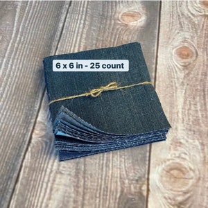 May include: A stack of 25 denim fabric squares, each measuring 6 inches by 6 inches, tied together with twine. The squares are a dark blue color and have a slightly textured surface.