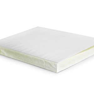 May include: A white blank notebook with a white cover and a cream-colored spine.