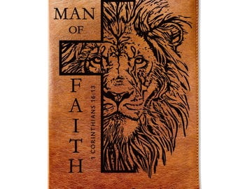 May include: A brown leather Bible cover with a cross design and a lion's face. The words "MAN OF FAITH" and "1 Corinthians 16:13" are etched on the cover. The name "Ryan Anderson" is also visible.