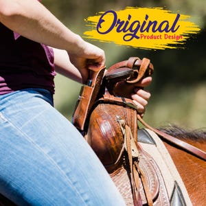 May include: A close-up of a brown leather saddle with intricate tooling and stitching. The saddle is on a horse, and the image includes the text "Original Product Design" in a yellow banner.