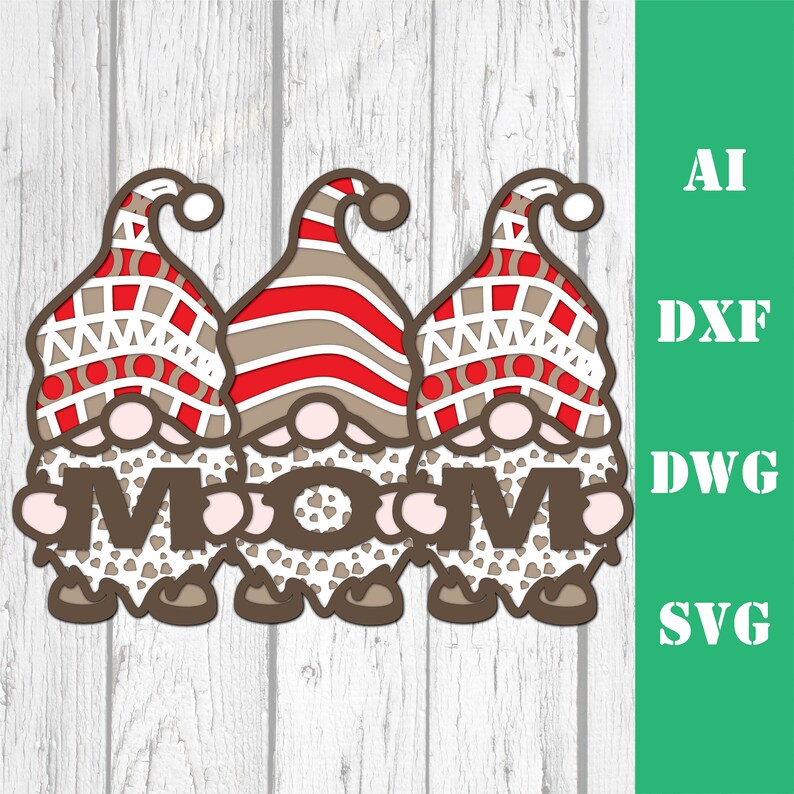May include: Three gnomes holding the word "MOM" in brown letters with white hearts. The gnomes are wearing red and white striped hats and have white beards with brown trim. The gnomes are standing on a white wooden background.