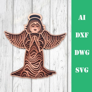 May include: A wooden angel ornament with intricate layered details. The angel is in a praying position with wings outstretched. The ornament is a light brown colour.