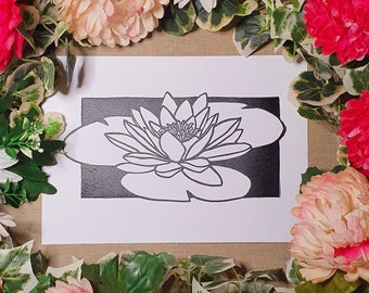 May include: A black and white line drawing of a water lily on a white background. The water lily is in the center of the image and is surrounded by a black border.
