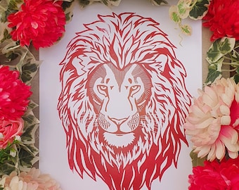 May include: Red and white lion head print on a white background. The lion's mane is detailed and the print is framed by red flowers.
