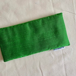 May include: Green eye pillow with a white label that says "Cicicrafts".
