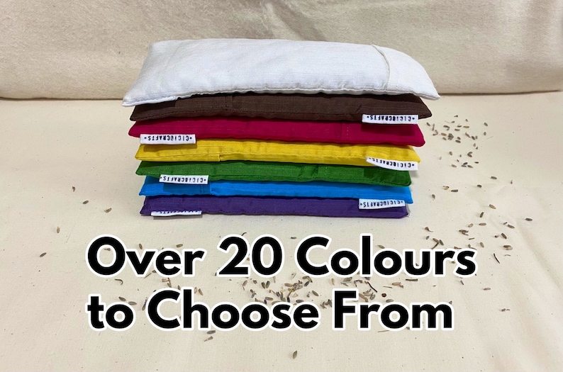 May include: A stack of seven eye pillows in various colors, including white, brown, red, yellow, green, blue, and purple. The text "Over 20 Colours to Choose From" is printed below the pillows.