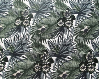 May include: A repeating pattern of tropical leaves and flowers in shades of green, gray, and white. Large, detailed leaves and clusters of flowers create a lush, botanical design. The background is a clean white.