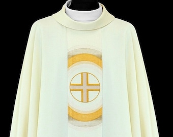 May include: A white liturgical vestment with a gold and white embroidered design featuring a circle with a cross inside.