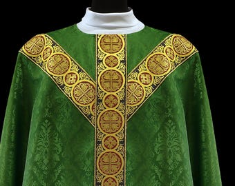 May include: Green liturgical vestment with gold and red embroidered detailing. The vestment features a white collar and a decorative pattern. The design includes a central vertical band and shoulder accents with circular and cross motifs.