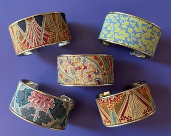 Stunning, unique cuff bracelet with rolled edges and featuring a beautiful Liberty of London Lawn Cotton insert. Fully adjustable.