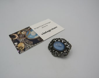 lovely vintage silver tone brooch, ornate design with a large blue cabochon, lovely vintage condition, 3.5cm length