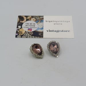 beautiful vintage silver tone clip on cocktail earrings, elegant design, clear rhinestones with a large purple central stone, 2.5cm length