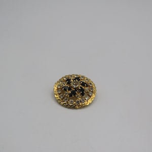 stunning gold tone vintage brooch , clear and black rhinestone detailing, excellent condition, sparkling piece, 3cm diameter, vintage brooch
