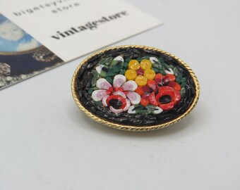 Lindo broche vintage em tom dourado com uma cena floral em micromosaico, uma peça de colecionador encantadora em excelente estado de conservação, com 3,5 cm de comprimento.