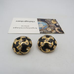 beautiful vintage gold tone clip on earrings, clear rhinestones, black enamel detailing, great condition, statement earrings, 2.5cm diameter