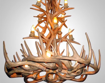 May include: A large antler chandelier with multiple light bulbs. The chandelier is made of natural antlers and has a rustic, natural look. The website address "www.antlerchandelier.net" is displayed below the chandelier.