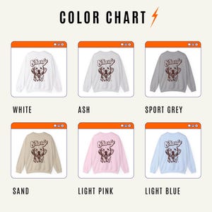 May include: Color chart showing six different colors of sweatshirts with a brown dog graphic and the word "Charly" on the back. The colors are white, ash, sport grey, sand, light pink, and light blue.