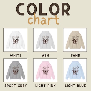 May include: Color chart showing different colors of a hoodie with a dog graphic and the word "Charly" on the back. The colors are white, ash, sand, sport grey, light pink, and light blue.