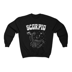 May include: Black sweatshirt with a white graphic of a scorpion and the word "SCORPIO" in a retro font. The graphic also includes the constellation Scorpio and the dates "October 23 - November 21".