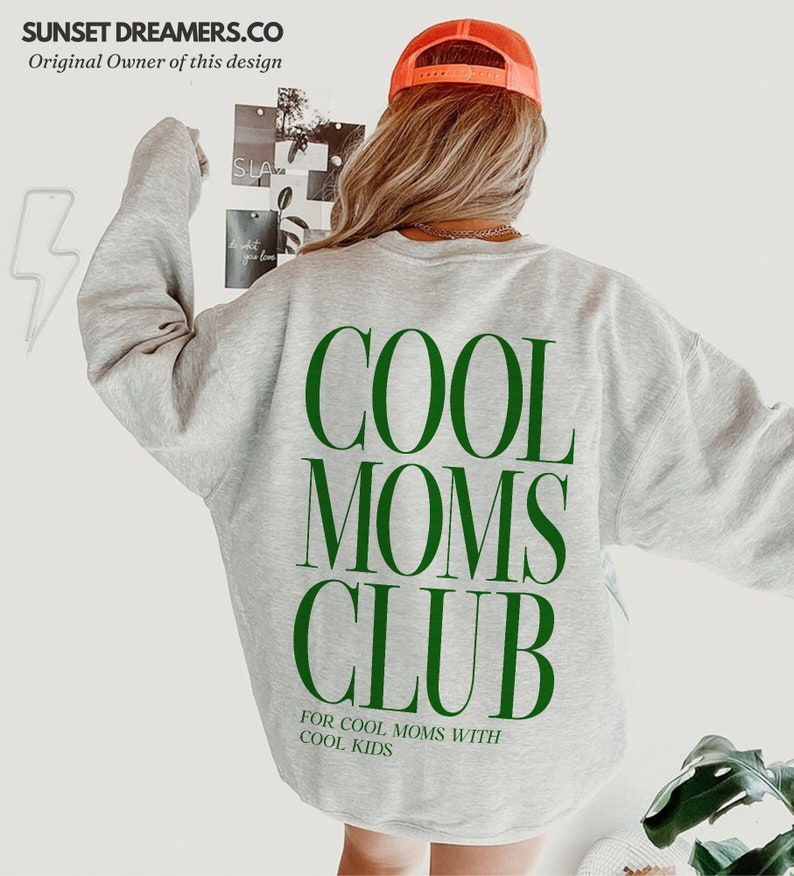May include: Gray sweatshirt with the text "COOL MOMS CLUB" in green letters. Below the text is the phrase "FOR COOL MOMS WITH COOL KIDS" in smaller green letters.