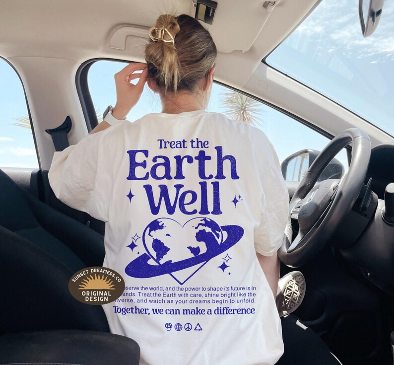 May include: White t-shirt with a blue graphic print of the Earth with the text "Treat the Earth Well" and a heart shape around the Earth. The text "Together, we can make a difference" is printed below the graphic.
