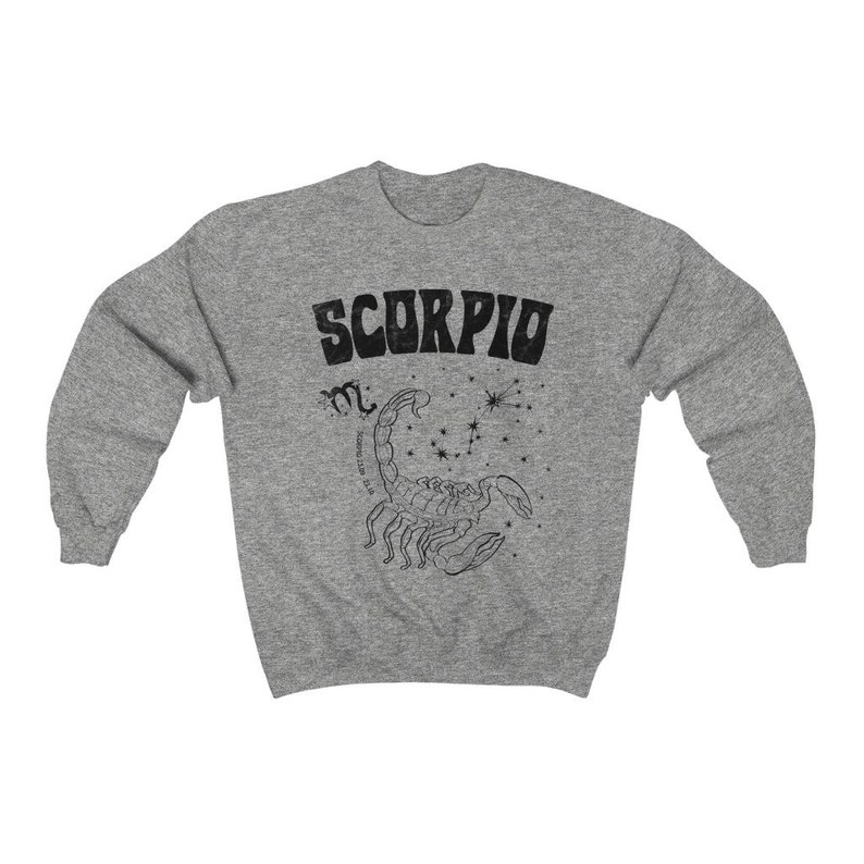 May include: Gray sweatshirt with a black graphic of a scorpion and the word "SCORPIO" in a retro font.