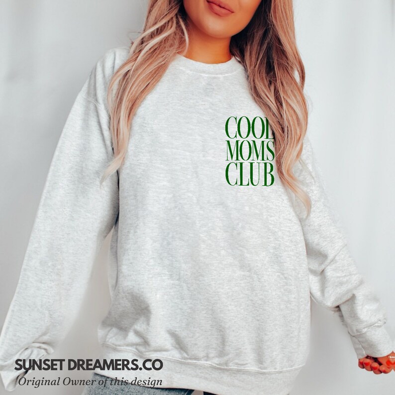 May include: A gray sweatshirt with the text "COOL MOMS CLUB" in green on the front.