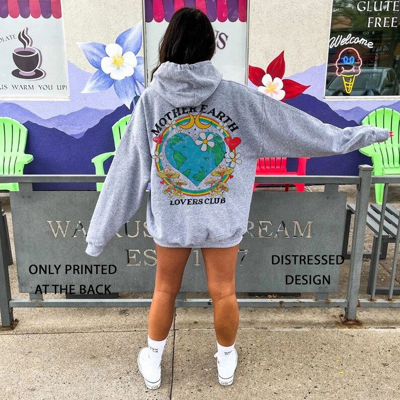 May include: Gray hooded sweatshirt with a graphic print of a colorful Earth with the text "Mother Earth Lovers Club" on the back.
