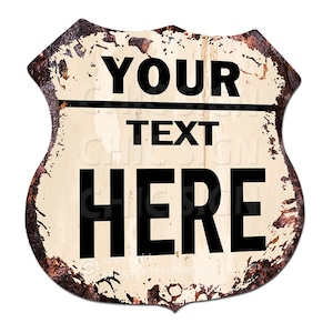 May include: A vintage-style metal sign with a white background and rusty edges. The sign features black text that reads "YOUR TEXT HERE".