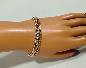 Pulsera vintage firmada Goldette, cadena de eslabones tipo curb y caja en tono dorado intenso de 7 pulgadas.