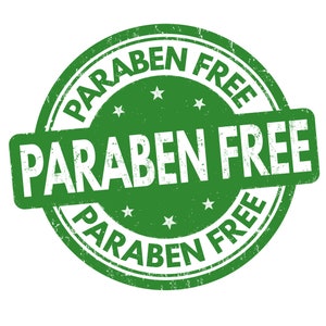 May include: Green round stamp with the text "PARABEN FREE" in white lettering. The text is repeated three times around the stamp.