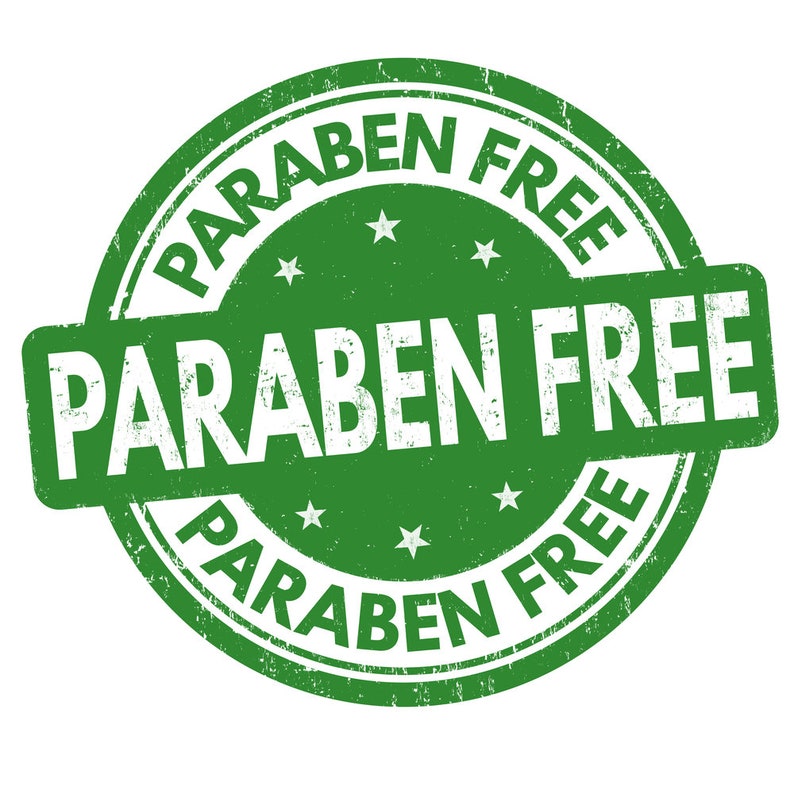 May include: Green round stamp with the text "PARABEN FREE" in white lettering. The text is repeated three times around the stamp.