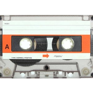 May include: A clear plastic cassette tape with an orange label. The label says "Type I Normal Position" and "Compact Cassette". The tape is labeled with the letter "A" and has a black index.