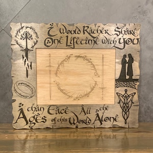 May include: A wooden picture frame with a decorative design featuring a tree, a ring, and the text "I would rather share one lifetime with you than  all the ages of this world alone".