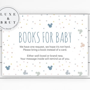 May include: A white card with blue and pink confetti and Mickey Mouse silhouettes. The text on the card reads "BOOKS FOR BABY" and includes a request to bring a book instead of a card.