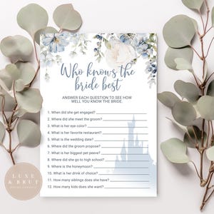 May include: A printable bridal shower game with a blue and white floral design and a silhouette of Cinderella's castle. The game is called "Who Knows the Bride Best?" and asks 12 questions about the bride.