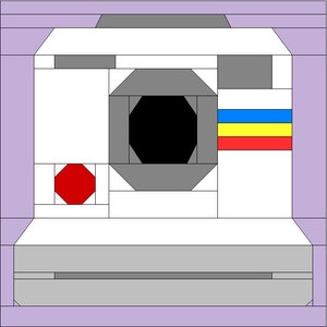 May include: A white and gray camera with a black lens and a red, yellow, and blue stripe on the side.