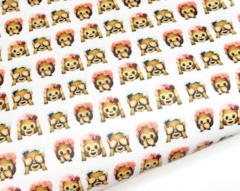 May include: White fabric with a repeating pattern of a monkey emoji covering its eyes with its hands and wearing a pink flower crown.